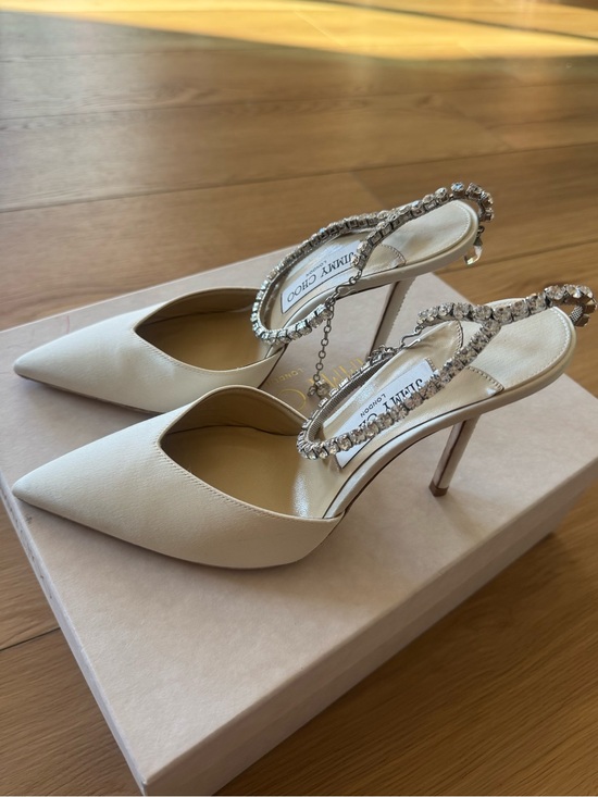 Jimmy Choo Shoes - JIMMY CHOO SAEDA 100
Ivory Satin Pumps with Crystal Embellishment (Size EU 37)
